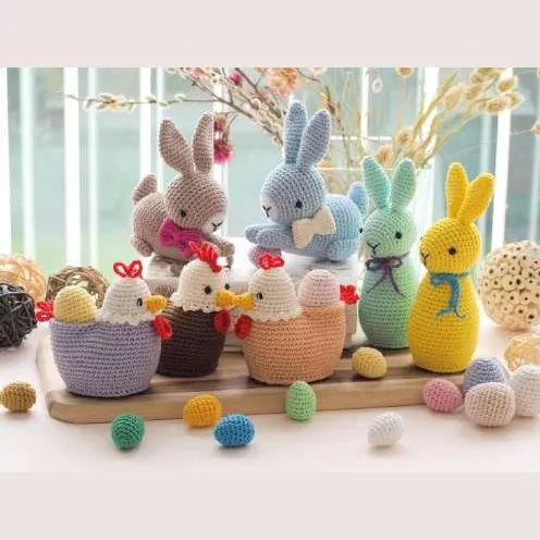 Colorful crochet amigurumi Easter bunnies and festive eggs in pastel and bright hues on wooden platters.