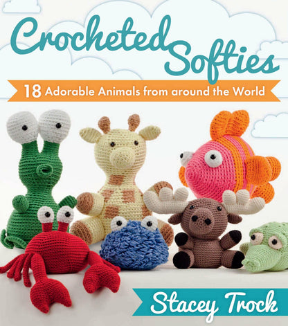 Colorful crocheted amigurumi animals including a frog, crab, giraffe, fish, and beaver on a soft cloud background.